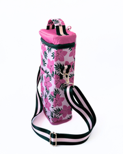 Pink floral water bottle holder with black and white striped strap on a white background