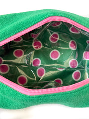 Inside of the green golf pouch showing the pink and white polka-dot lining