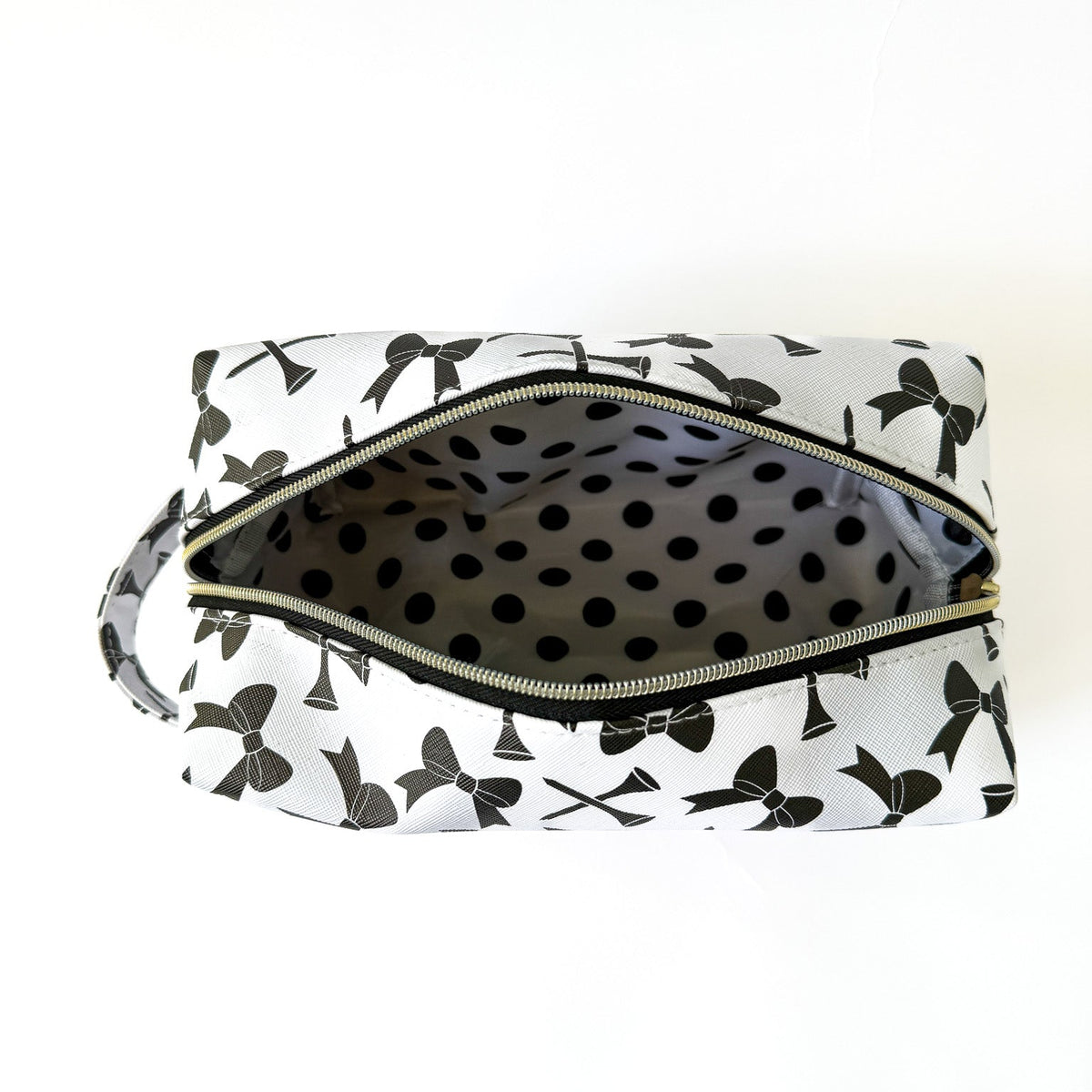 Inside of the Bows and Tees golf pouch showing the black and white print lining