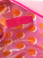 Inside of the pink golf pouch showing the orange and white polka-dot lining