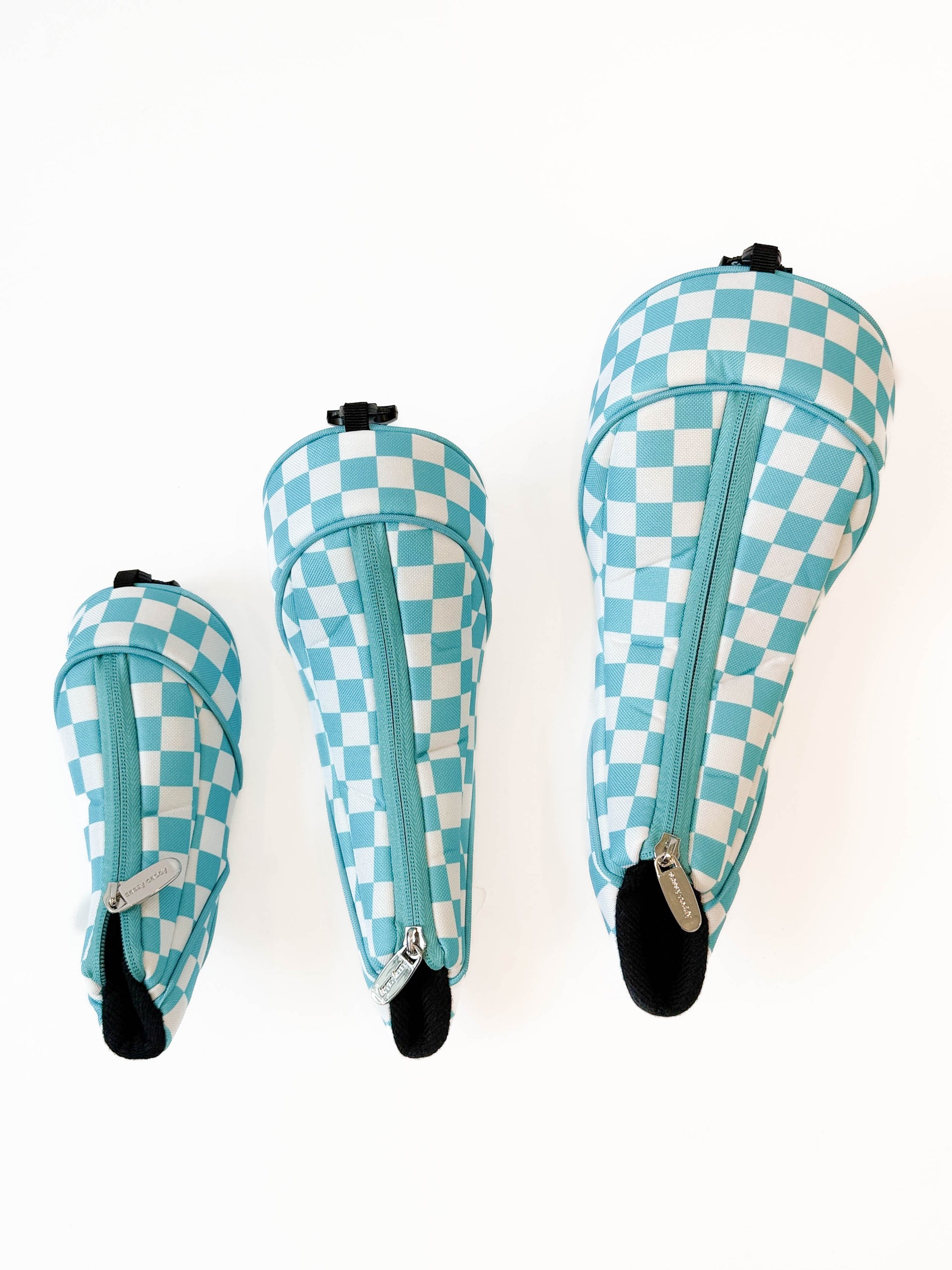 Three checkered headcovers on a white background