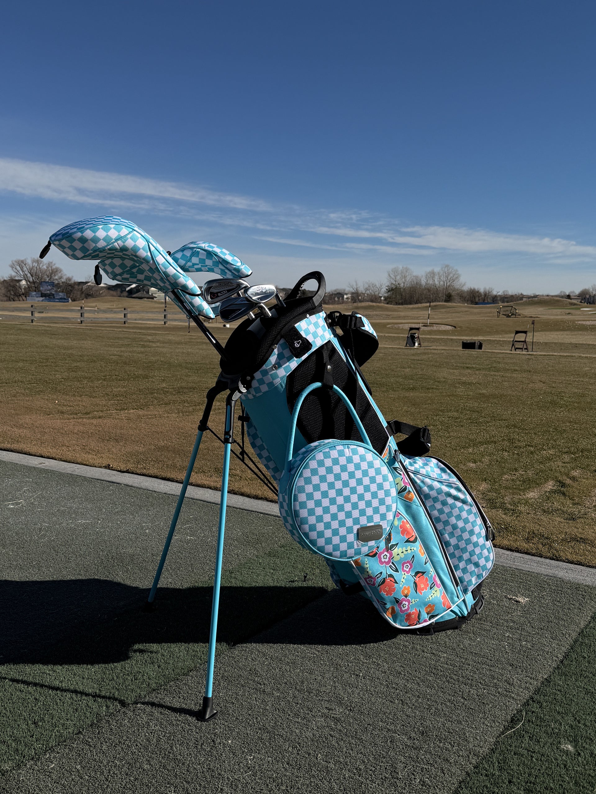 Golf bag with checkered design on a golf course